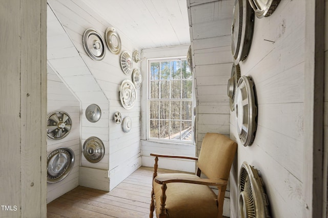 laundry room featuring wood walls and light wood-type flooring