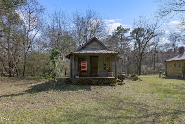 bungalow-style home with a front yard