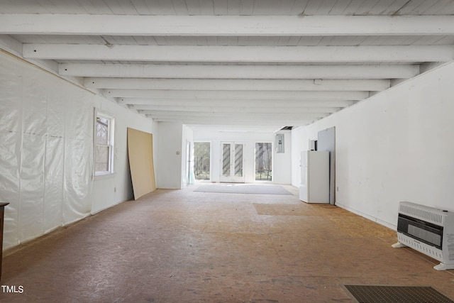 empty room featuring beam ceiling and a healthy amount of sunlight