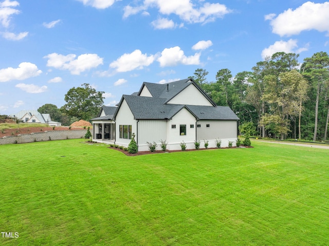 back of house featuring a lawn