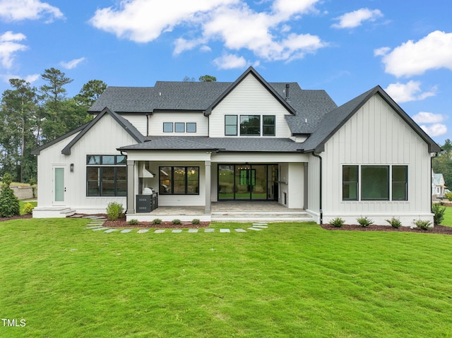 rear view of house featuring a yard