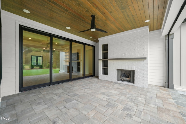 unfurnished living room with ceiling fan, a fireplace, built in features, and wooden ceiling