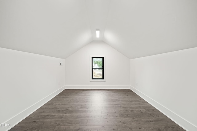 additional living space with lofted ceiling and dark wood-type flooring