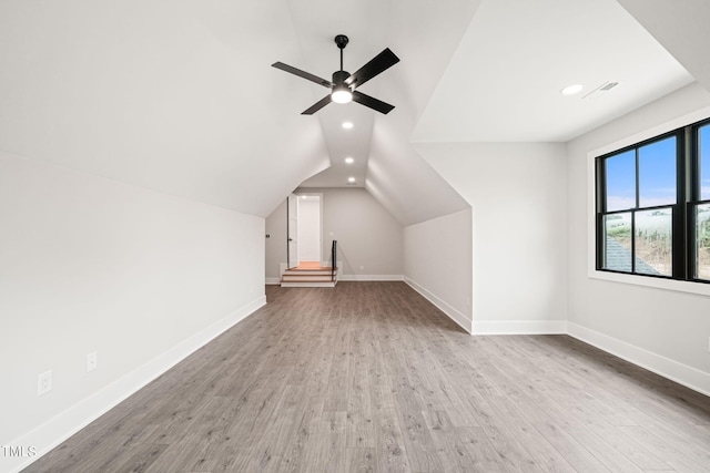 additional living space with ceiling fan, vaulted ceiling, and light hardwood / wood-style floors