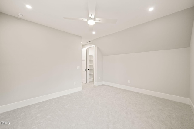 bonus room with lofted ceiling, ceiling fan, and light carpet