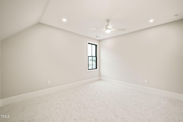 unfurnished room featuring vaulted ceiling, ceiling fan, and carpet floors