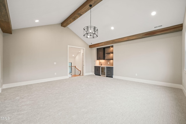 unfurnished living room with carpet floors, a notable chandelier, and lofted ceiling with beams