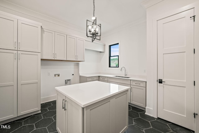 kitchen with hanging light fixtures, sink, a kitchen island, a chandelier, and crown molding