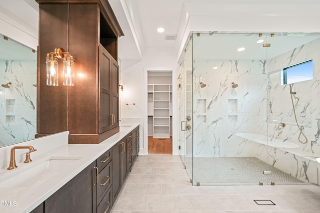 bathroom with tile walls, tile patterned flooring, a shower with door, and vanity