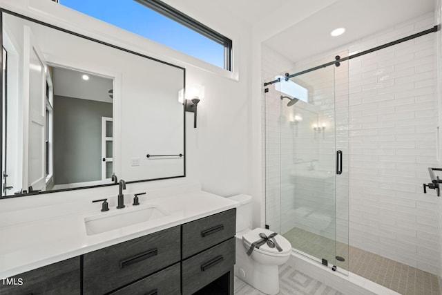 bathroom with vanity, toilet, and an enclosed shower