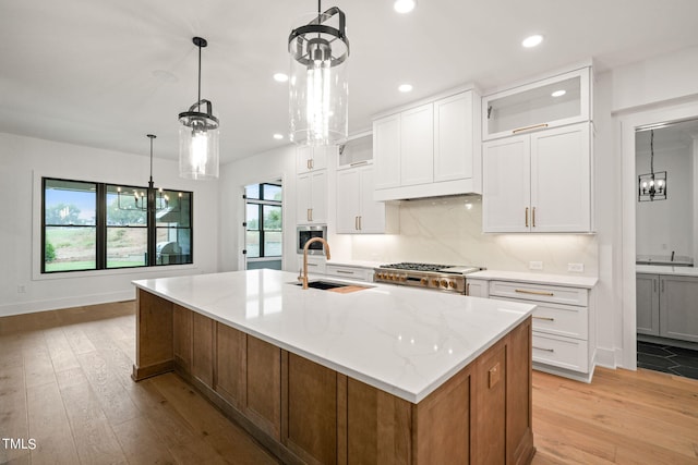 kitchen with appliances with stainless steel finishes, a healthy amount of sunlight, and white cabinetry