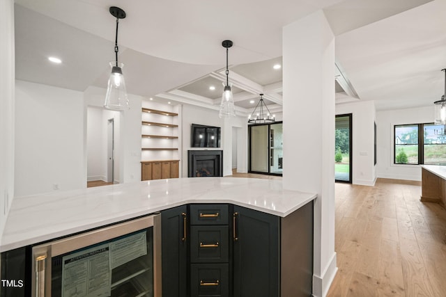 kitchen with beverage cooler, light hardwood / wood-style floors, and hanging light fixtures