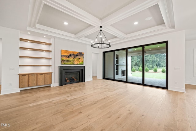 unfurnished living room featuring coffered ceiling, an inviting chandelier, light hardwood / wood-style flooring, and beam ceiling