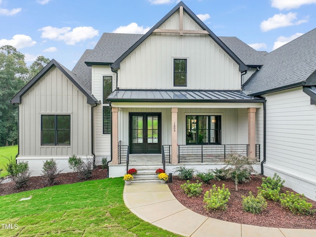 modern inspired farmhouse featuring a front yard and a porch