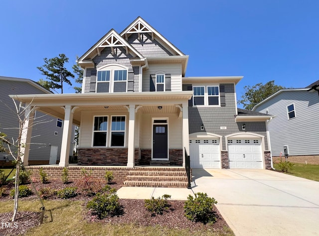 craftsman-style house featuring covered porch and a garage