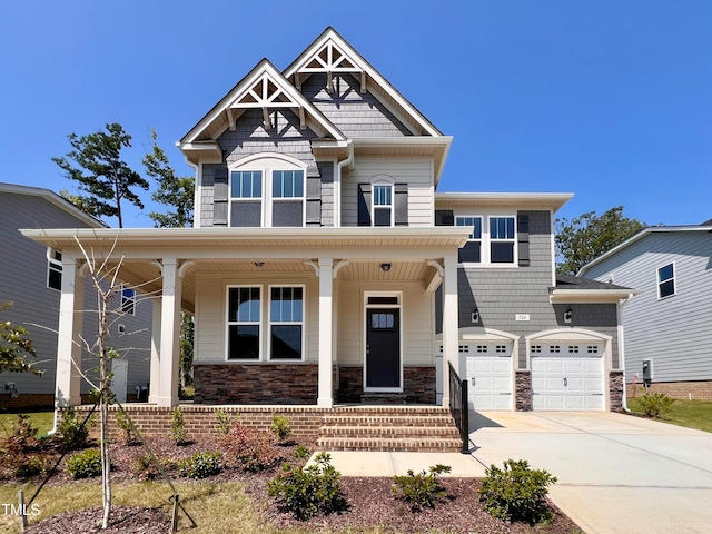 craftsman house featuring covered porch and a garage