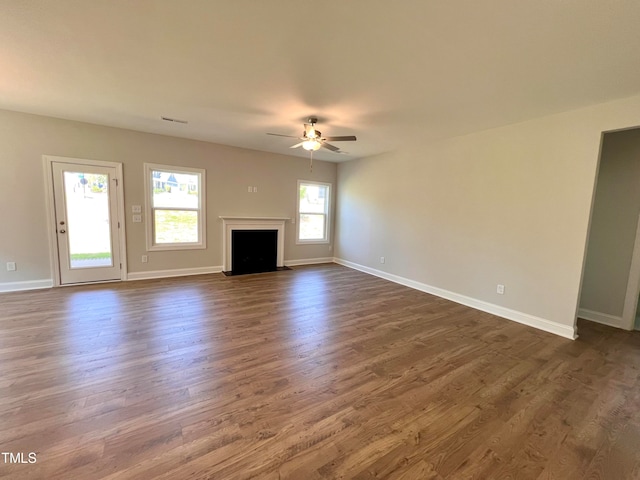 unfurnished living room with ceiling fan and dark hardwood / wood-style floors