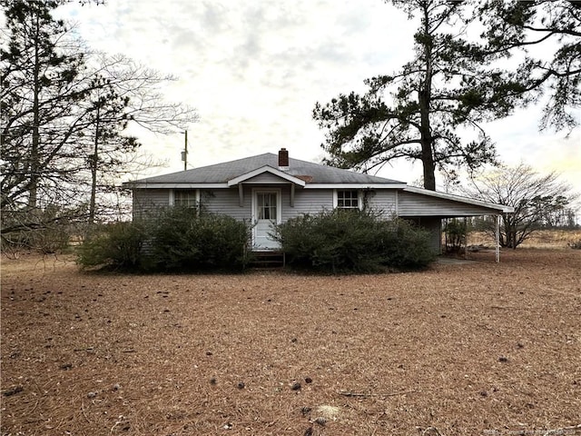 ranch-style house featuring a carport