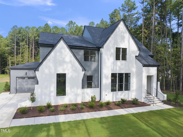 view of front of house with a garage and a front lawn