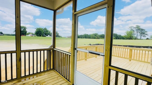 sunroom with a healthy amount of sunlight and a rural view