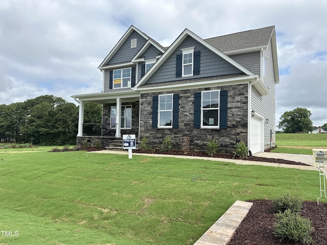 craftsman-style house featuring a front lawn, a porch, and a garage