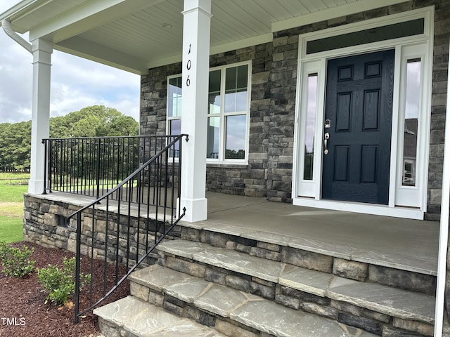 view of exterior entry featuring a porch