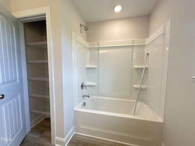 bathroom featuring tub / shower combination and hardwood / wood-style flooring