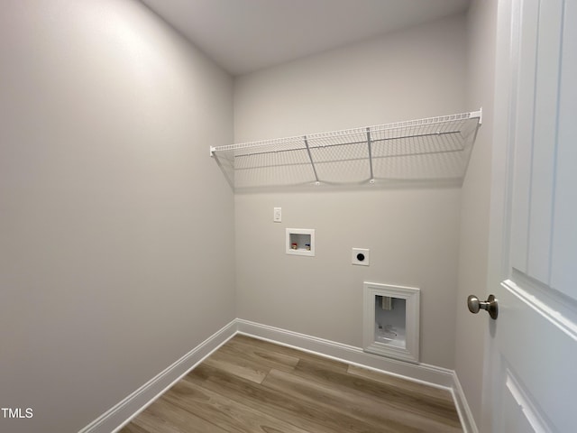 clothes washing area featuring hardwood / wood-style flooring, hookup for a washing machine, and electric dryer hookup