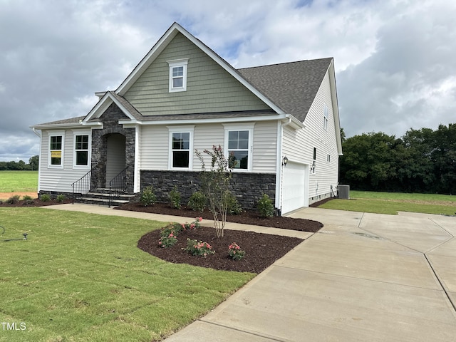 view of front of home with a front lawn and a garage