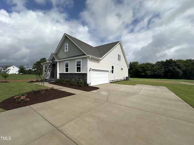 view of side of property featuring a garage and a yard