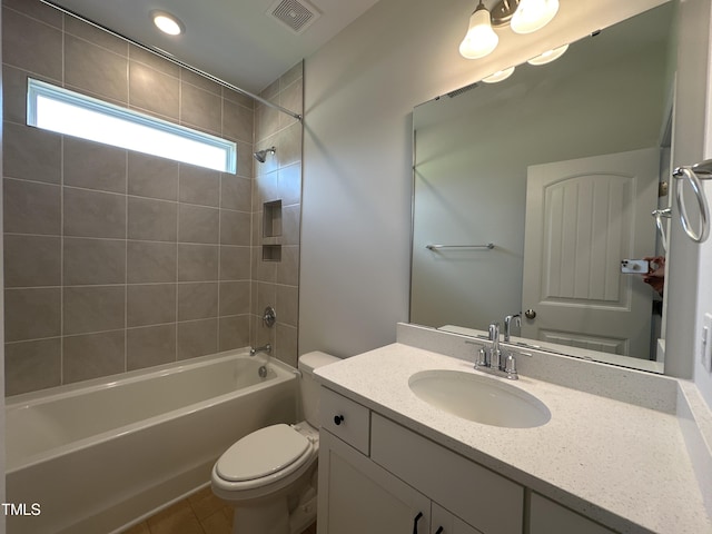 full bathroom with toilet, tiled shower / bath combo, vanity, and tile patterned floors