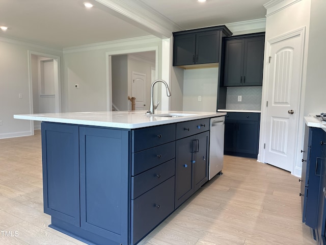 kitchen with sink, dishwasher, crown molding, and an island with sink