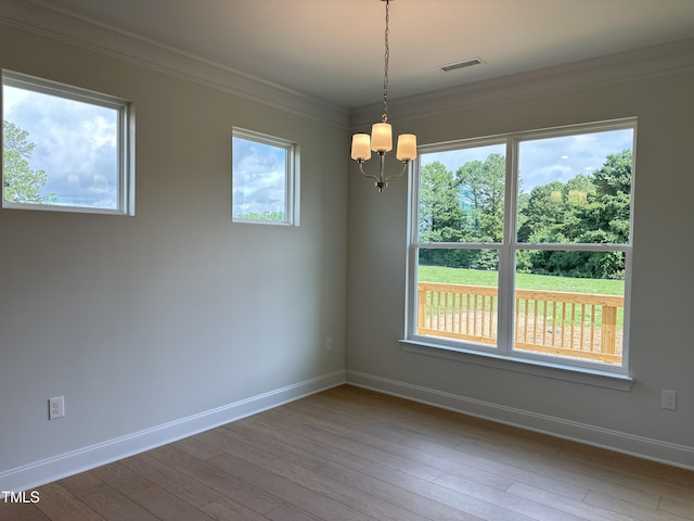 spare room with a wealth of natural light and ornamental molding