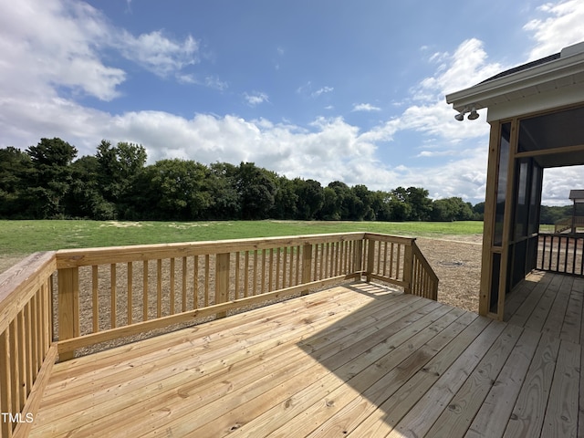 wooden deck featuring a lawn