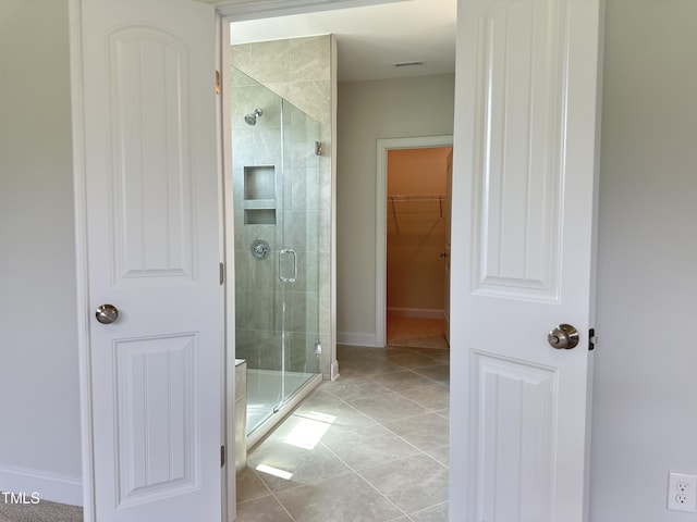 bathroom with tile patterned floors and a shower with shower door