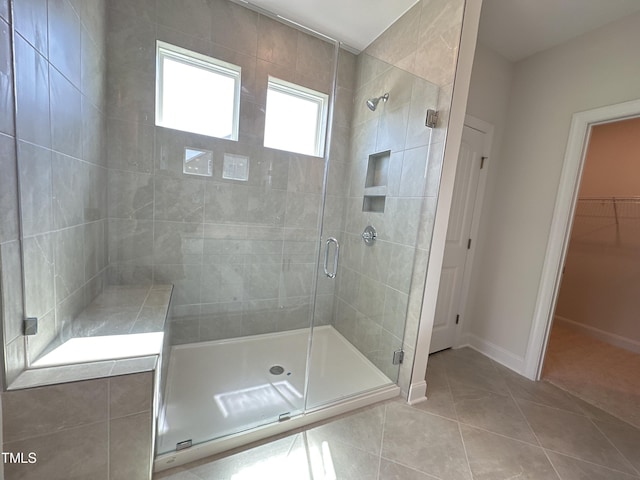 bathroom with tile patterned floors and a shower with shower door