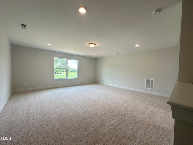 unfurnished room featuring light carpet