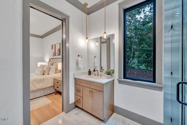 1312 Hunting Ridge Rd, Raleigh, NC 27615 - ensuite bathroom with vanity, marble look tile flooring, and a shower with door