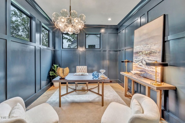 home office with crown molding, a notable chandelier, and light wood-type flooring