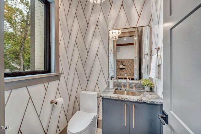 1312 Hunting Ridge Rd, Raleigh, NC 27615 - half bathroom with vanity, toilet, a decorative wall, and backsplash