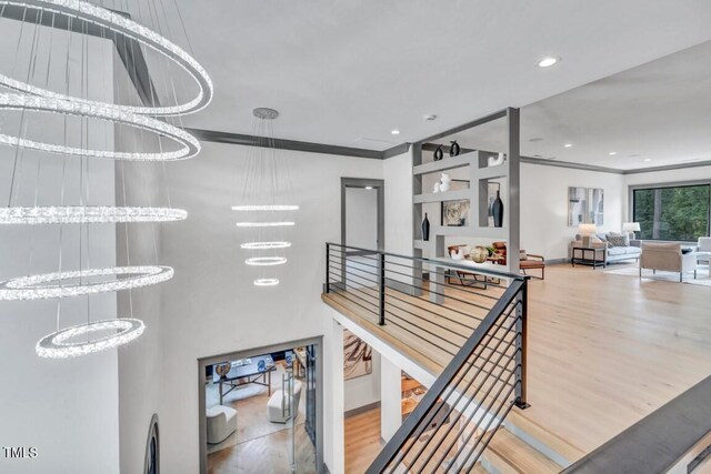 1312 Hunting Ridge Rd, Raleigh, NC 27615 - stairs with wood finished floors, crown molding, a chandelier, recessed lighting, and baseboards