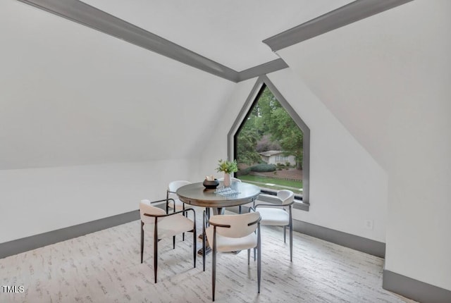 1312 Hunting Ridge Rd, Raleigh, NC 27615 - dining room with lofted ceiling, wood finished floors, and baseboards