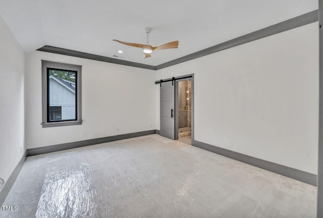 1312 Hunting Ridge Rd, Raleigh, NC 27615 - empty room featuring baseboards, ceiling fan, a barn door, vaulted ceiling, and recessed lighting