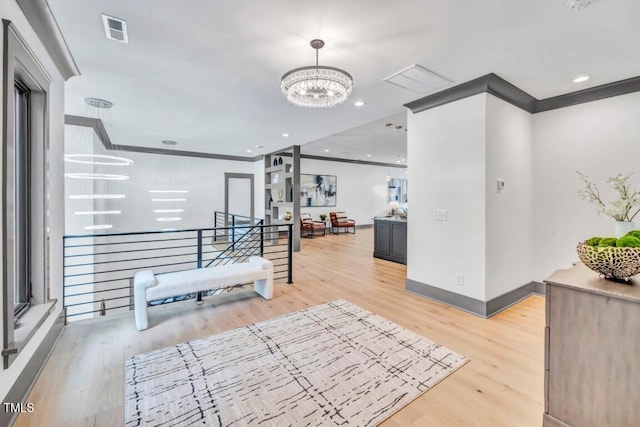 1312 Hunting Ridge Rd, Raleigh, NC 27615 - interior space with a chandelier, an upstairs landing, wood finished floors, baseboards, and crown molding