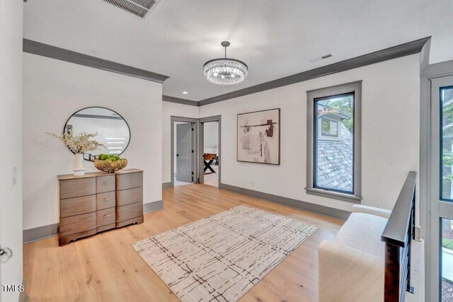 1312 Hunting Ridge Rd, Raleigh, NC 27615 - entrance foyer with a chandelier, baseboards, and light wood-style flooring