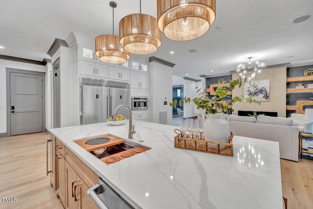 1312 Hunting Ridge Rd, Raleigh, NC 27615 - kitchen with stainless steel appliances, light wood-type flooring, glass insert cabinets, decorative light fixtures, and recessed lighting