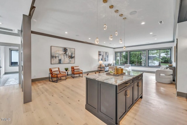 1312 Hunting Ridge Rd, Raleigh, NC 27615 - kitchen featuring open floor plan, light stone countertops, baseboards, light wood-style floors, and a kitchen island