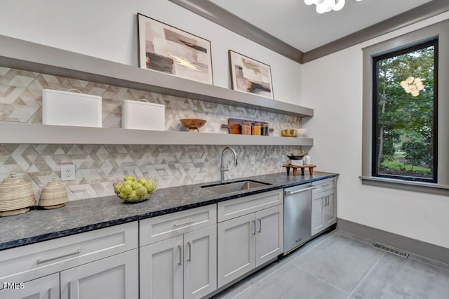 1312 Hunting Ridge Rd, Raleigh, NC 27615 - bar area featuring stainless steel dishwasher, a sink, backsplash, light tile patterned floors, and baseboards