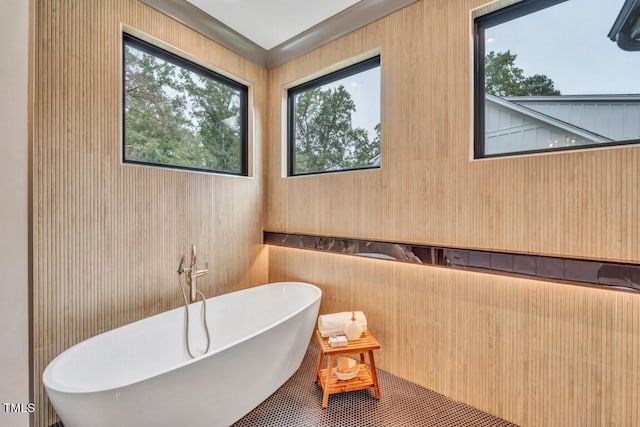 1312 Hunting Ridge Rd, Raleigh, NC 27615 - bathroom with a freestanding bath, healthy amount of natural light, and wooden walls