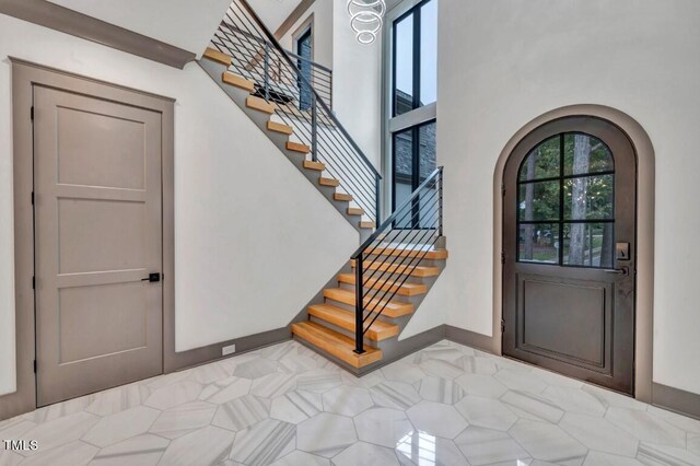 1312 Hunting Ridge Rd, Raleigh, NC 27615 - entrance foyer with arched walkways, stairway, and baseboards